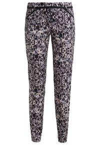 Pantalon slim avec motif abstrait noir, blanc et beige, ceinture noire et poches avant zippées.