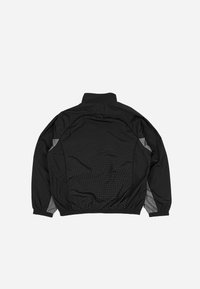 Black windbreaker jacket with a high collar, elastic cuffs, and a grid pattern accent on the back. Features gray side panels and a relaxed fit.
