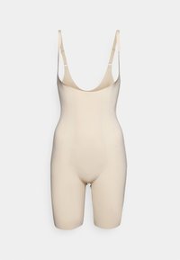Beige bodysuit made of smooth, stretchy fabric. Features thin adjustable straps and a form-fitting design with a mid-thigh length.
