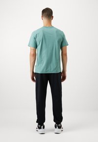 Nike Performance JOGGER - Tepláky - black/white