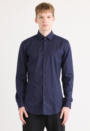 Navy blue long-sleeve shirt with a subtle herringbone pattern, button-down collar, and six black buttons down the front. Smooth fabric texture.
