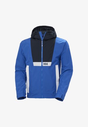 Chaqueta impermeable azul con capucha, con panel frontal negro, acentos blancos y puños elásticos. Cierre frontal con cremallera.