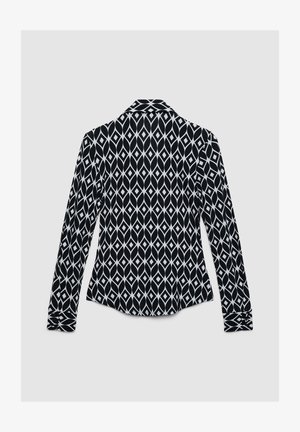 Langarmhemd in Schwarz mit weißem Diamantmuster. Verfügt über einen Kragen und geknöpfte Manschetten. Glatte Stoffstruktur.