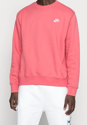 Sudadera rosa hecha de un tejido suave con cuello redondo, puños y dobladillo acanalados. Presenta un logo blanco de Nike en el pecho.