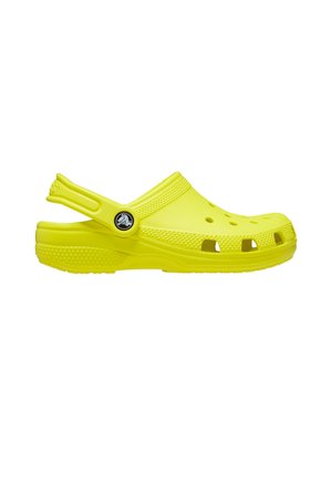 Felgele slip-on klomp met ventilatiegaten en een beweegbare hielband, zijaanzicht op een witte achtergrond.