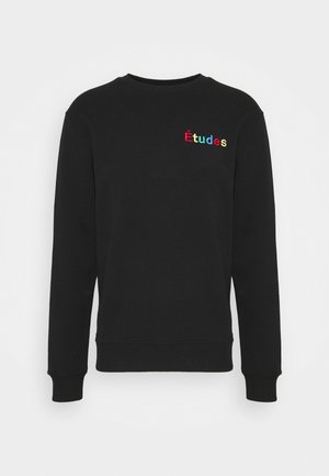 Musta puuvillainen collegepaita, jossa pyöreä pääntie ja pitkät hihat. Rintapäällä kirjailtu "Études"-logo värikkäillä kirjaimilla.