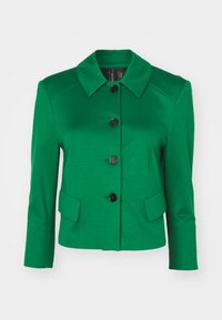 Green jacket made from smooth fabric, featuring a pointed collar, black buttons, and two front pockets. Tailored fit with three-quarter sleeves.