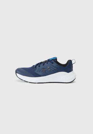 Navy blue athletic shoe with a mesh upper, white midsole, black accents, textured design, and blue tongue detail. Lace-up style.