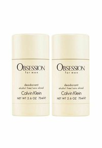 Calvin Klein Obsession för män deodorant, två stift, krämlik färg, cylindrisk design, 75ml, alkoholfri, med svart text på förpackningen.