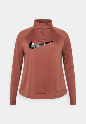 Bluza Nike z długim rękawem w kolorze rdzy z suwakiem do połowy i czarnym logo Nike Swoosh na piersi.