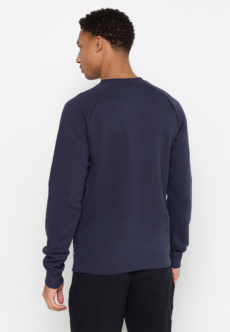 Dunkelblaues Sweatshirt mit langen Raglanärmeln, einem Rundhalsausschnitt sowie gerippten Bündchen und Saum. Hergestellt aus einem strukturierten Baumwollmischgewebe.