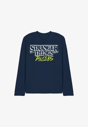 Navy long-sleeve shirt with white and neon green text reading "Stranger Things Tales from 85" on the front center.