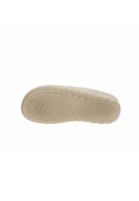 Sole di scarpa beige con motivi testurizzati, linee di presa prominenti e dettaglio del logo. Il design presenta una forma curvata per un supporto ergonomico.