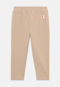 Beiga leggings med ett mjukt, stretchigt tyg. Har en elastisk midja och en liten logotyp på övre vänstra sidan. Slät textur.