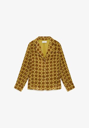 Camicia a maniche lunghe con bottoni, presenta un motivo geometrico giallo e marrone, con una texture morbida e un colletto, progettata per una vestibilità comoda.