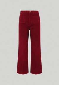 Punaiset corduroy-mahankäyrä housut korkealla vyötäröllä, viisi taskua ja nappisulku. Kankaan pinta on pehmeä ja näyttää selvästi ribbitty.