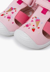 Pink fabric sandals with white rubber soles. Features embroidered ice cream and strawberry designs. Adjustable straps for secure fit.