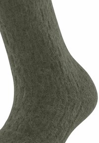 Grüne, strukturierte Wollsocke mit geripptem Design, ausgestattet mit einer nahtlosen Zehenkappe und einem engen Sitz, ideal für Wärme und Komfort.