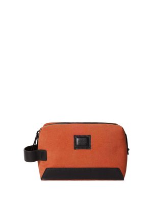 Orange canvas toiletry bag with a black leather base and handle. Features a zip closure and a square logo patch on the front.