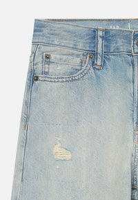 Light blue denim jeans with a faded texture, distressed detailing, and silver hardware accents. Features a traditional five-pocket design.