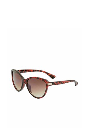 Lunettes de soleil œil de chat en écaille avec verres marron dégradés et branches fines, inclinées pour montrer les détails du côté droit et de la monture avant.