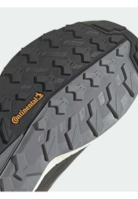 Musta kumipohja, jossa on korostunut monisuuntainen kuvio. "Continental"-logo oranssina kannan lähellä. Raekuvioitu pinta.