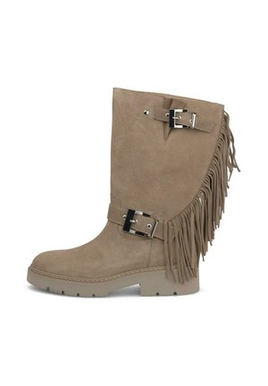 Bota de ante beige hasta media pantorrilla con flecos laterales, dos hebillas plateadas y suela plana de goma con dibujo para mejor agarre.