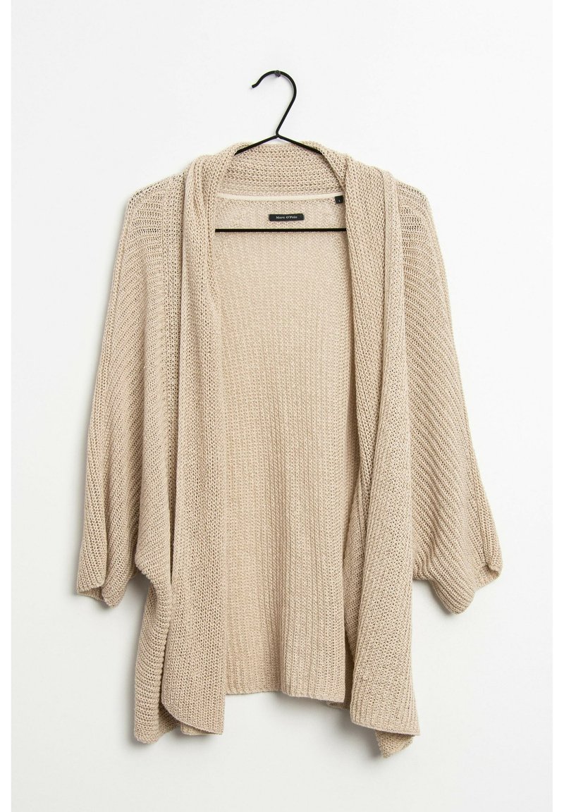 Beige, öppen cardigan med lös passform, långa ärmar och en texturerad stickad mönster. Hänger från en svart krok.