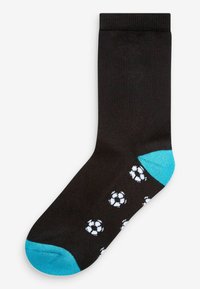 Chaussettes noires avec un bout et un talon turquoise, ornées d'un motif répétitif de ballons de football blancs. Fabriquées dans un matériau lisse et extensible.