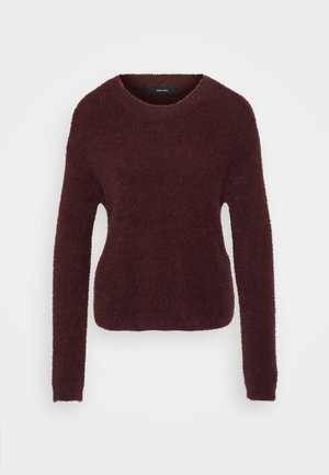 Suéter texturizado burdeos con cuello redondo y mangas largas. Material suave y esponjoso con una silueta ligeramente ajustada. Sin herrajes visibles.