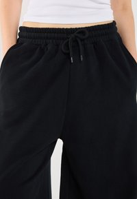 YOURTURN BARREL FIT UNISEX - Tréningruha alsók - black