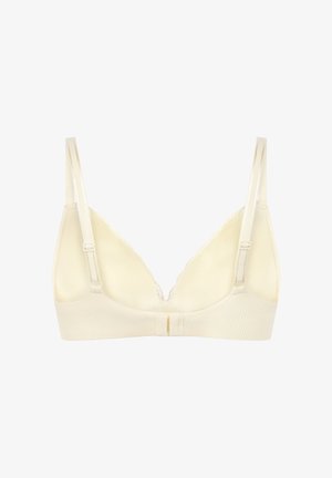 Soutien-gorge sans fil crème clair avec un tissu doux et texturé, bordure en dentelle, col en V, et bretelles réglables. Dispose d'une fermeture à agrafe dans le dos.