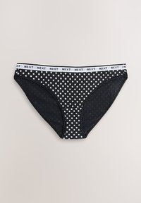 Mustad bikiinipüksid valgete täppidega, millel on kontrastne valge elastne vöökoht "NEXT" logoga. Pehme, veniv materjal.