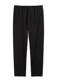 Black pants with a soft, elastic waistband, featuring two side pockets and a tapered leg design. Smooth texture with no visible patterns.