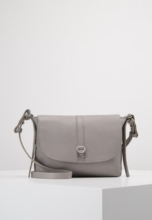 Light gray leather crossbody bag with adjustable strap and front flap secured by a small silver buckle, resting on a white surface.