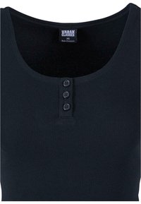 Tmavě námořnický top bez rukávů s ribovanou texturou, vyznačující se kulatým výstřihem a třemi černými knoflíky na předním zapínání. Vyrobeno z měkkého materiálu.
