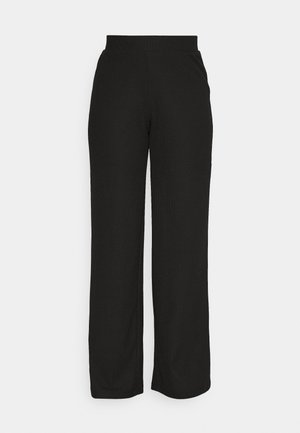 Pantalons larges à côtes noires avec une taille élastique, présentant une texture lisse et une silhouette droite. Pas de marque ni de détails visibles.