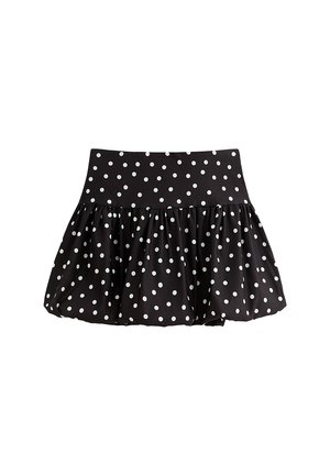 Gonna nera con pois bianchi, caratterizzata da una vita ampia e un design svasato con volant. Materiale morbido con una texture liscia.