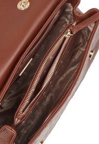 Brown leather handbag with gold hardware. Interior features multiple compartments, including zippered pockets and a patterned lining.