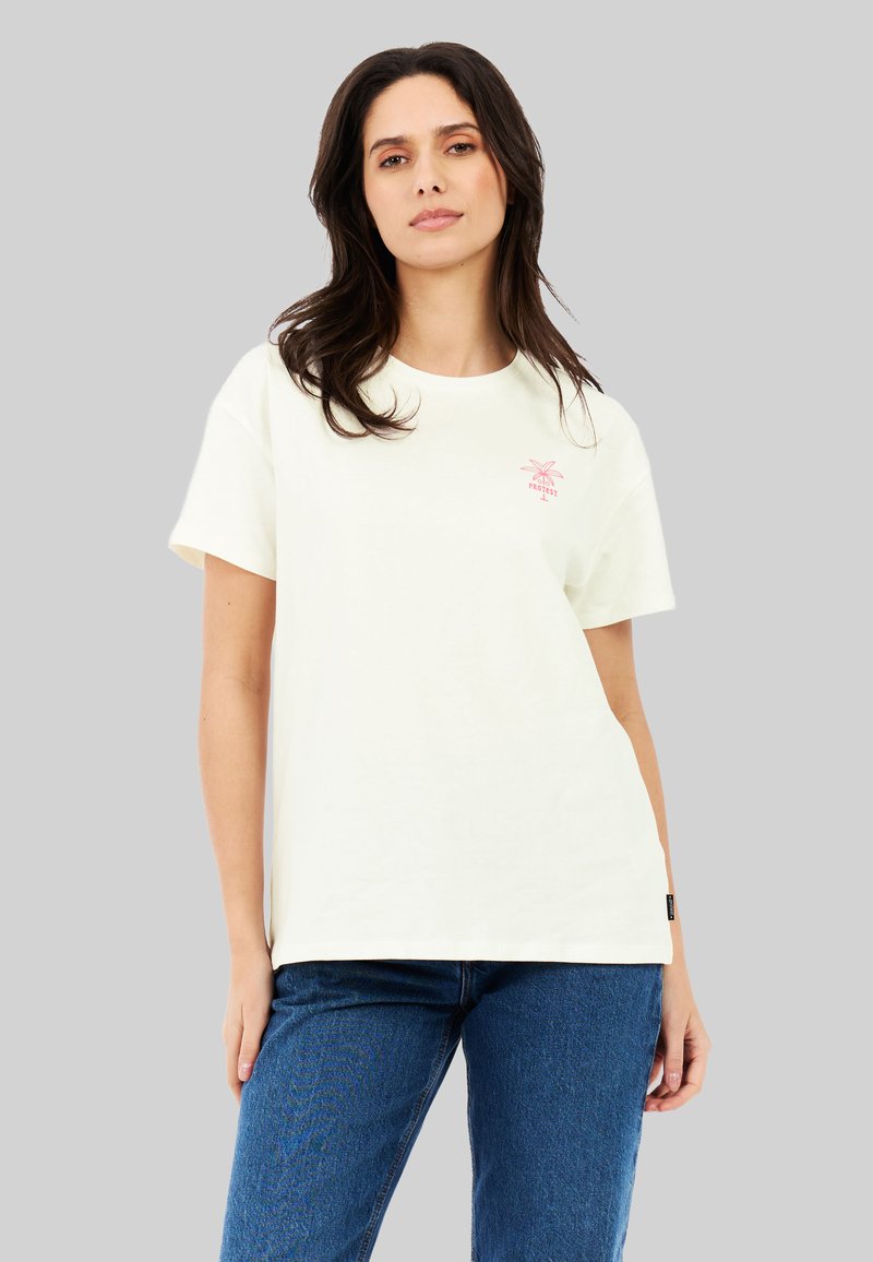 Crème korte mouw t-shirt met een roze palmbomenafbeelding op de borst. Gemaakt van katoen, heeft een relaxte pasvorm en een ronde halslijn.