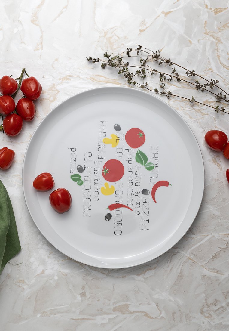 Runde weiße Keramikplatte mit bunten Illustrationen von Gemüse (Tomaten, Chili, Oliven) und Text in einem Rasterschema.