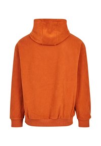 Oranžna kapuca iz mehkega materiala s teksturirano površino. Ima sproščen kroj in elastične manšete na robu in rokavih.