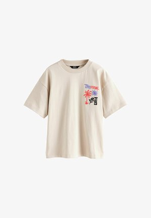 Béžové tričko s krátkym rukávom s textom "Tropical Vibes", červenou palmou, purpurovým slnkom a čiernou grafikou listu na ľavej strane hrudníka.