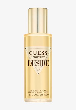Guldfarvet cylindrisk flaske med Guess Seductive Desire duftmist, 250 ml / 8,4 fl. oz., med en skinnende guldkapsel.