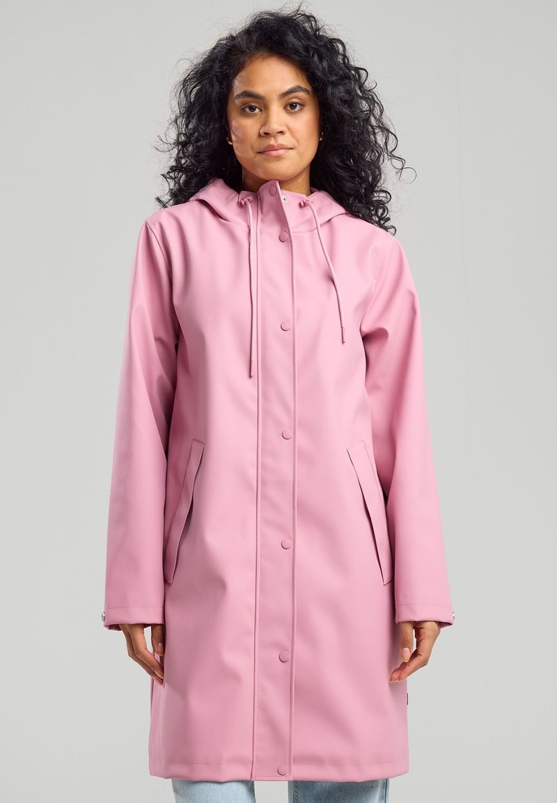 Pink waterproof raincoat with a hood, featuring snap closures and side pockets. Smooth texture and mid-length design.