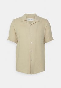 Een lichtbeige shirt met korte mouwen, gemaakt van textuurstof. Voorzien van een knoopsluiting aan de voorkant en een klassieke kraag. Heeft een subtiel gerimpeld patroon over het hele oppervlak.