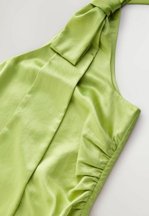 Sleeveless, light green dress with soft satin texture, featuring a tied shoulder strap and gathered detailing on the side.