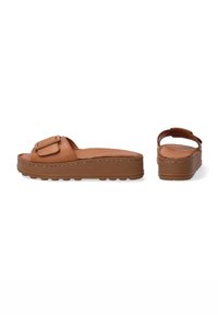 Brown leather slide sandals with a wide toe strap featuring a rectangular buckle, thick platform sole, and textured bottom for grip.
