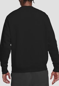 Black crew neck sweatshirt with long sleeves, ribbed cuffs and hem, made from soft fabric. No visible logos or designs on the back.