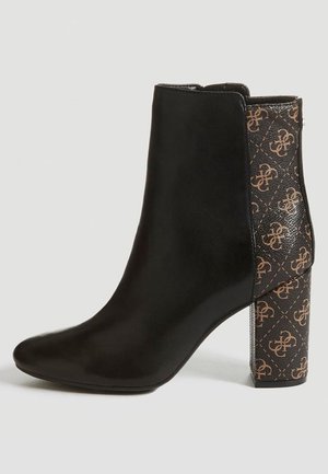 Black ankle boot with smooth leather upper and patterned fabric side; features a chunky, printed block heel with logo detail.
